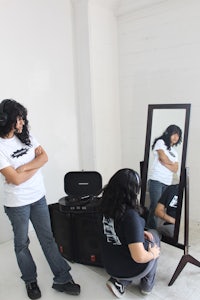 a woman standing in front of a mirror